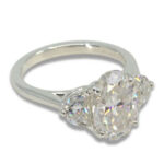Three Stone Oval Moissanite 4.43ctw. Ring with Half Moon Accents