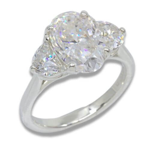 Three Stone Oval Moissanite 4.43ctw. Ring with Half Moon Accents