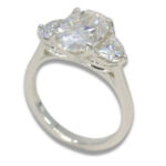 Three Stone Oval Moissanite 4.43ctw. Ring with Half Moon Accents