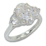 Three Stone Oval Moissanite 4.43ctw. Ring with Half Moon Accents